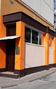 an orange and white building with a window at Hostel Korona in Belgorod
