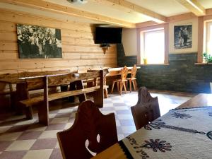 a dining room with a table and chairs and a television at Pokoje Gościnne U Jaśka in Ząb