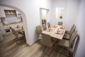 a dining room with a table and chairs and a kitchen at MINIDORM ROOMS IN HEART OF CITY CENTER in Maribor