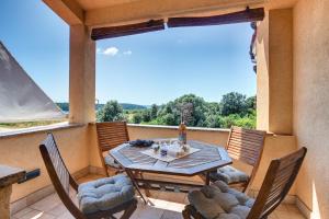 a patio with a table and chairs on a balcony at Apartments Buic in Vinkuran