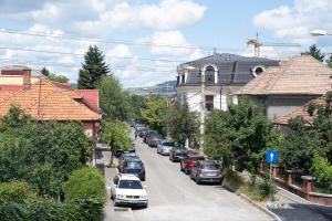 a street with cars parked on the side of the road at The Residence Central Jacuzzi Boutique (Adult Only) in Cluj-Napoca