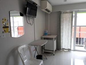 a small kitchen with a table and chairs in a room at Cha-Am Fish Star Hotel in Cha Am +53 photos