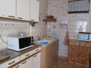 a kitchen with a microwave and a sink at GITE A SAINT-REMY (21500) in Saint-Rémy