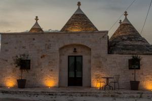 a building with a table and chairs in front of it at Trulli Nannì in Locorotondo