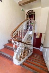 a spiral staircase in a building with red floors at Hotel Le Flore in Fréjus