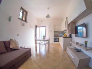 a living room and kitchen with a couch and a table at La Cornice dei Monti in Tramonti
