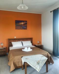 a bedroom with a bed with two towels on it at Marmaron Rooms in Agiokampos