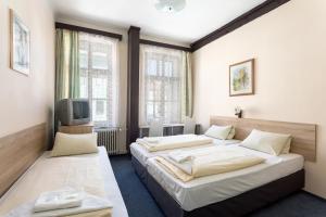 Postel nebo postele na pokoji v ubytování Penzion Hotel Morrison