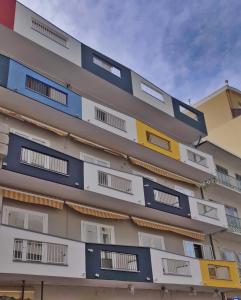 a tall building with colorful windows on it at Casa Comisso in Caorle