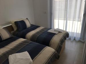 Łóżko lub łóżka w pokoju w obiekcie Mini Villa "Las Palmeras"