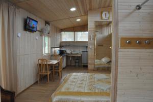 a room with a kitchen and a dining room at Papartis in Ažuluokesa