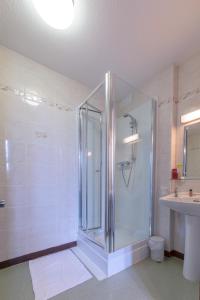 a bath room with a shower and a toilet at Muthu Royal Thurso Hotel in Thurso