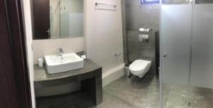 a bathroom with a sink and a toilet at Aenaon Rooms in Nafplio