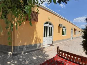 a building with a red rug in front of it at Khiva Indi Guest House in Khiva