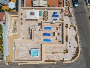 an overhead view of a building with a swimming pool at Dimora Rizzo con tappeti di pietra in Leuca