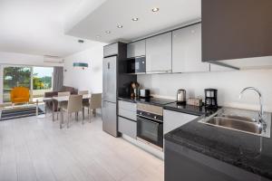 a kitchen with stainless steel appliances and a dining room at Victory Village Sea Views in Quinta do Lago