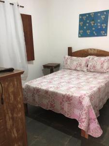 Ένα ή περισσότερα κρεβάτια σε δωμάτιο στο Casa Recanto dos Encantos!