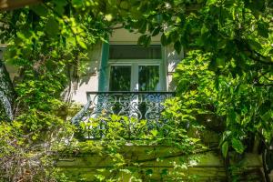 a bench in front of a window on a house at Le Windsor, Jungle Art Hotel in Nice