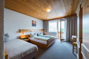 Кровать или кровати в номере Ferienpension Steiner