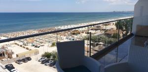a balcony with a view of the beach and the ocean at Bluemarina Apartamente in Mamaia