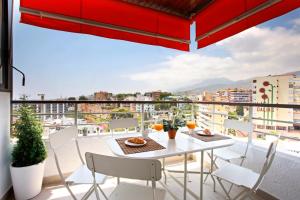 a balcony with a table and chairs and a view at Nogalera Terrace by Madflats Collection in Torremolinos