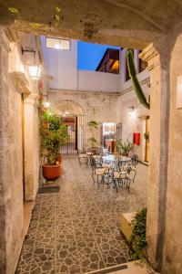 an indoor patio with tables and chairs and plants at Santa Marta Hotel in Arequipa