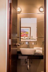 a bathroom with a sink and a mirror at Santa Marta Hotel in Arequipa +40 photos