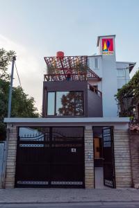 a building with a garage with a sign on top at ART Hostel in Tirana