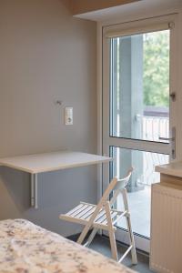 a desk and a chair in a room with a window at Boleslav Home in Sucha Beskidzka