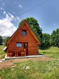 a log cabin with a table in front of it at Nikitovic house in Žabljak