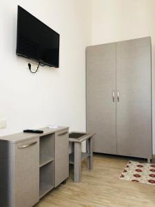 an office with a desk and a tv on a wall at Guesthouse Family in Batumi