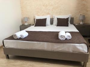 a bedroom with a large bed with two pillows at Guesthouse Family in Batumi