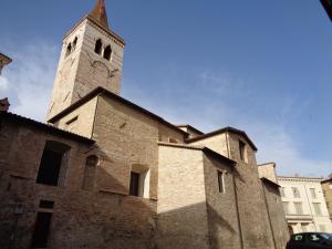 a church with a clock tower on top of it at Affittacamere Badia in Foligno