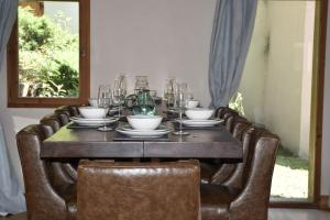 a dining room table with chairs and glasses on it at Chalet Beaufort in Saint-Martin-de-Belleville +51 photos