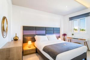מיטה או מיטות בחדר ב-Talos Luxury Suites