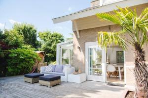 a patio with a couch and a table at Luxury villa on peaceful location. Boat optional in Vinkeveen