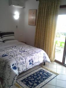 a bedroom with a bed and a window and a rug at Appart-Hotel Cabo Dream in Cabo Negro +12 photos