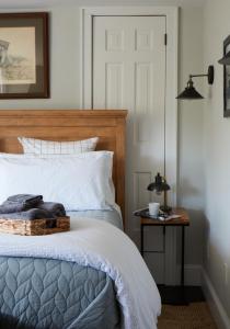 a bedroom with a bed with a wooden head board at Wm. Farmer and Sons in Hudson