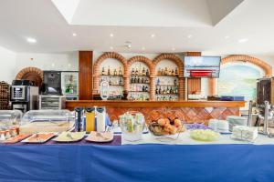 a blue table with food on it in a kitchen at Residencial Mares in Tavira