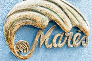 a close up of the word muse written in gold at Residencial Mares in Tavira