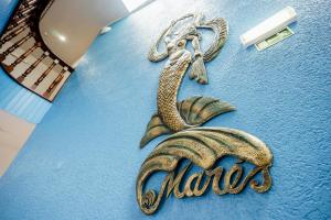a drawing of a mermaid on a blue wall at Residencial Mares in Tavira