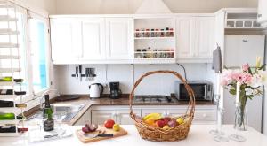 a kitchen with a basket of fruit on a counter at Absolute Beachfront Apartment in Famara