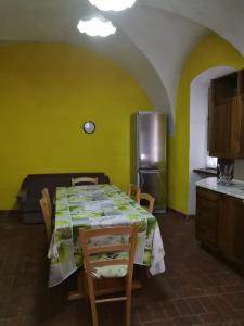 a kitchen with a table with chairs and a refrigerator at Condino in Condino