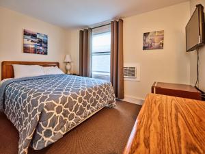 a hotel room with a bed and a window at Atlantic Sands in Hampton