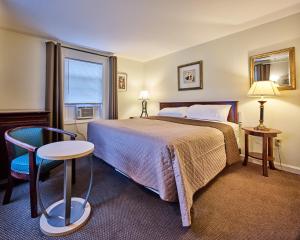 a hotel room with a bed and a window at Atlantic Sands in Hampton