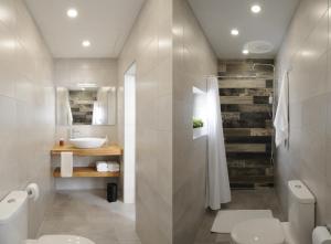 a bathroom with a toilet and a sink at Number 28 - The house with the blue door in Żebbuġ