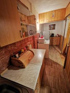 a kitchen with wooden cabinets and a counter top at Apartment Phoenix No.12 in Korenica