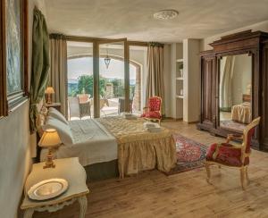 a bedroom with a large bed and a large window at La Vecchia Sassa in Montaione
