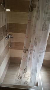 a shower curtain with a picture of shoes on it at Art in Nova Varoš