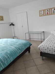 a bedroom with a bed and a table and a mirror at Grand maison de caractère in Montjaux